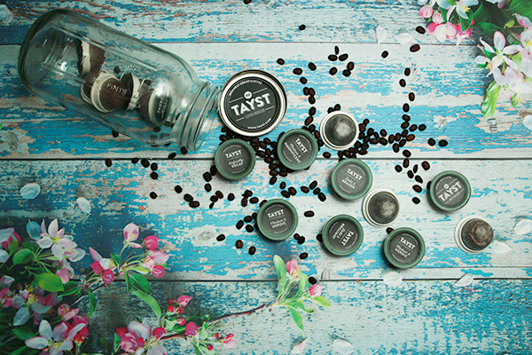 tayst coffee pods with coffee beans and mason jar on table 