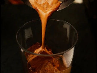 drinking glass filled with iced coffee