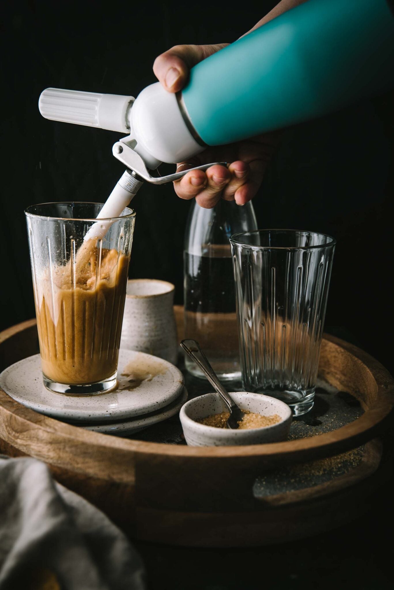 itro Cold Brew being poured from a whipped cream dispenser.