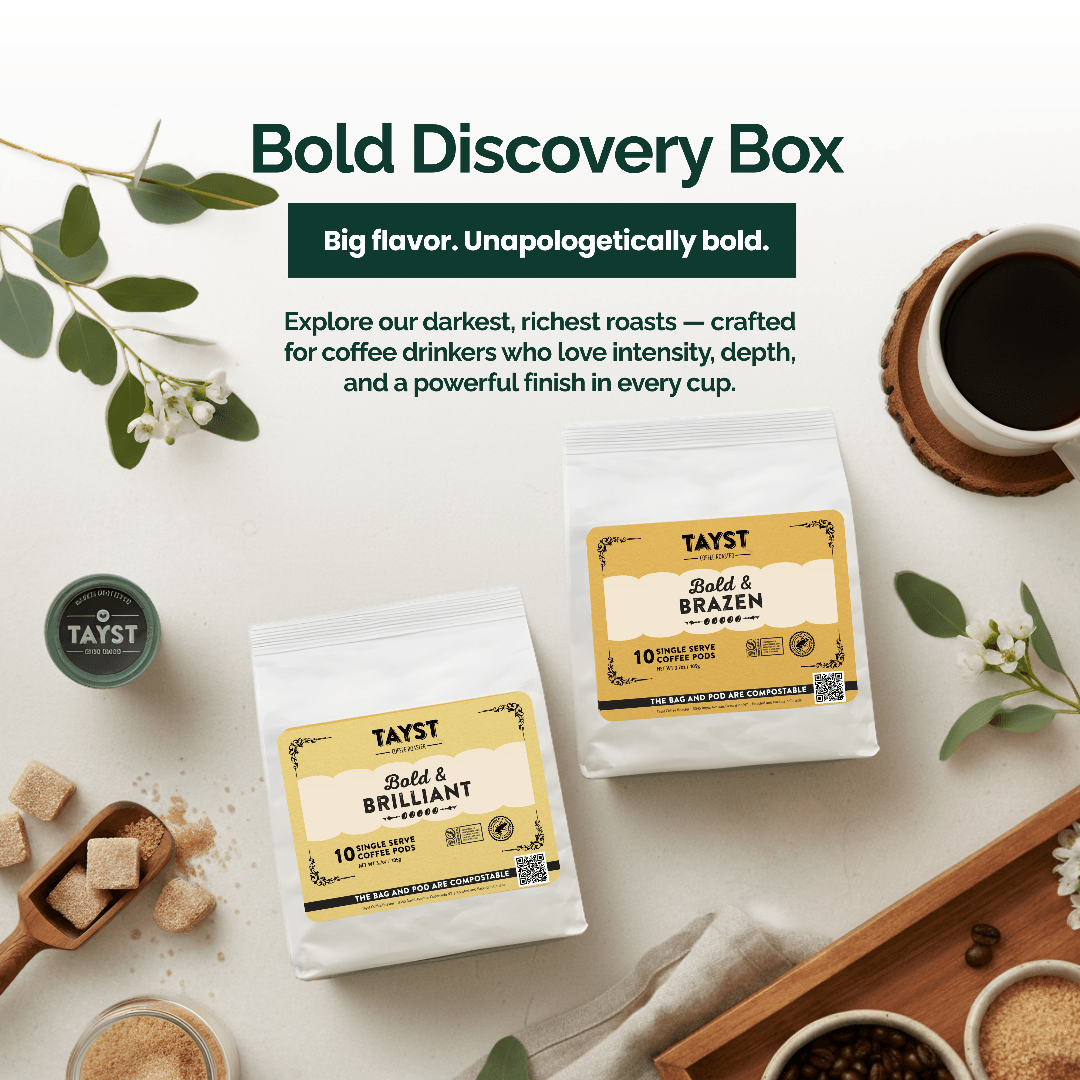 Tayst coffee packaging with 'Bold Discovery Box' branding on a white surface with coffee-related items.