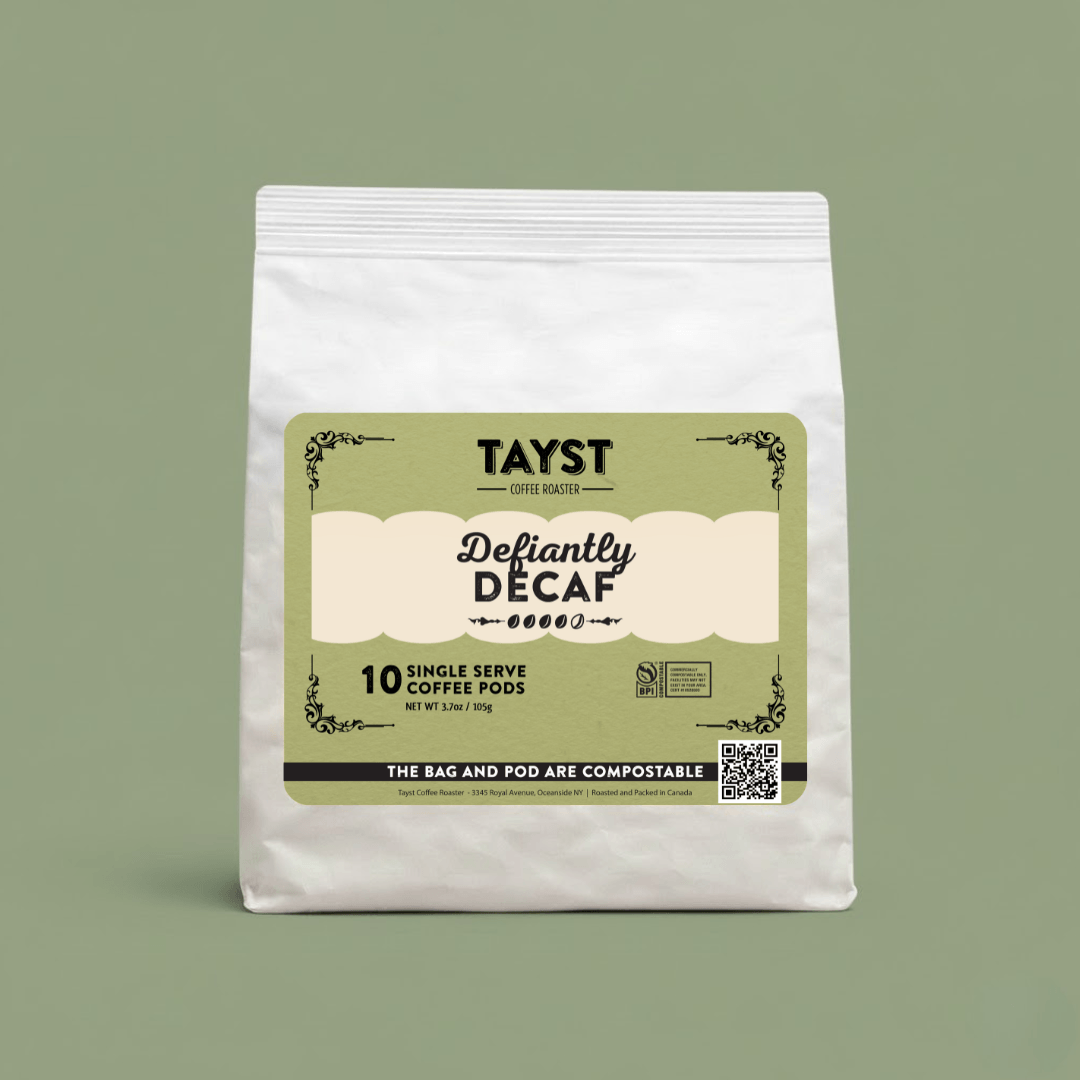 Tayst Defiantly Decaf coffee pods packaging on a green background
