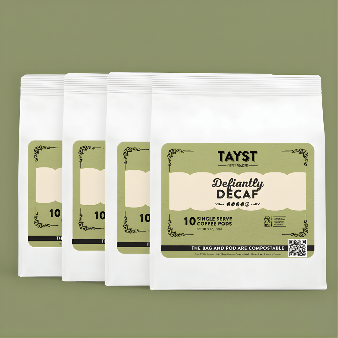 Pack of Tayst Defiantly Decaf coffee pods on a green background