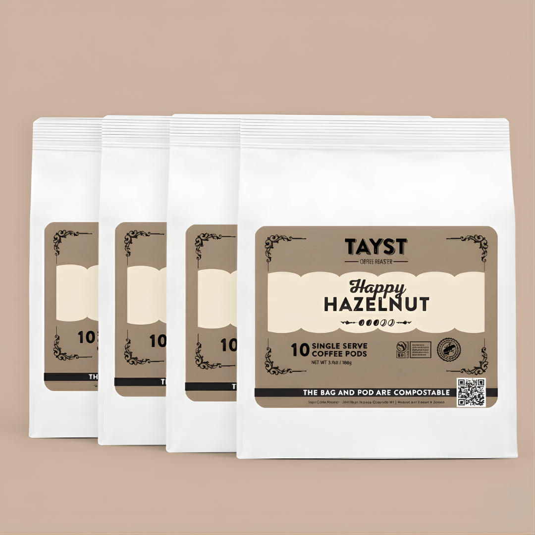Pack of Tayst Happy Hazelnut coffee pods on a beige background