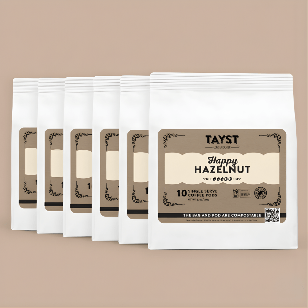Tayst Happy Hazelnut coffee pods on a beige background