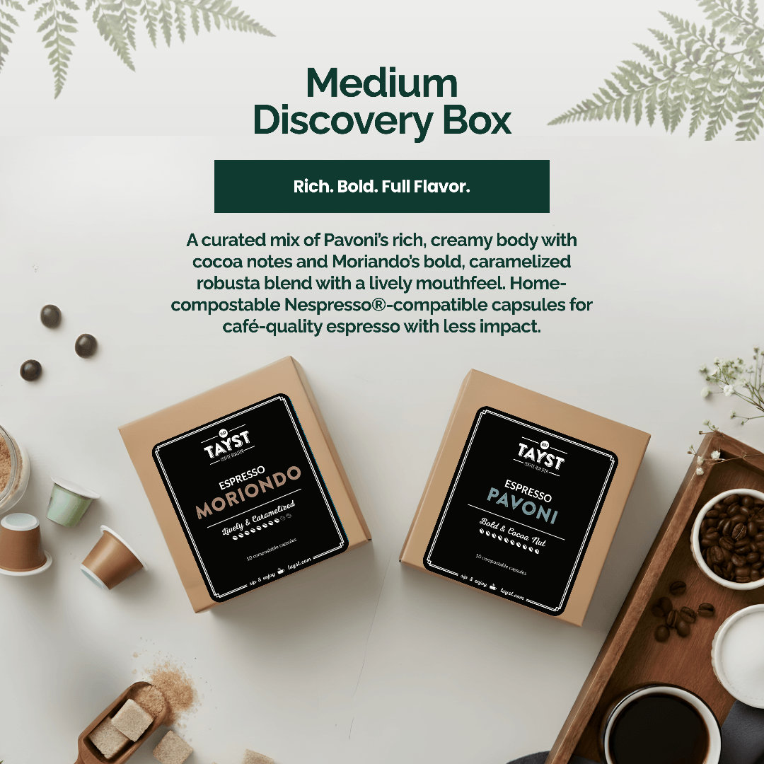 Two coffee capsule boxes labeled 'Espresso Morando' and 'Espresso Pavoni' on a white surface with coffee beans and a cup.