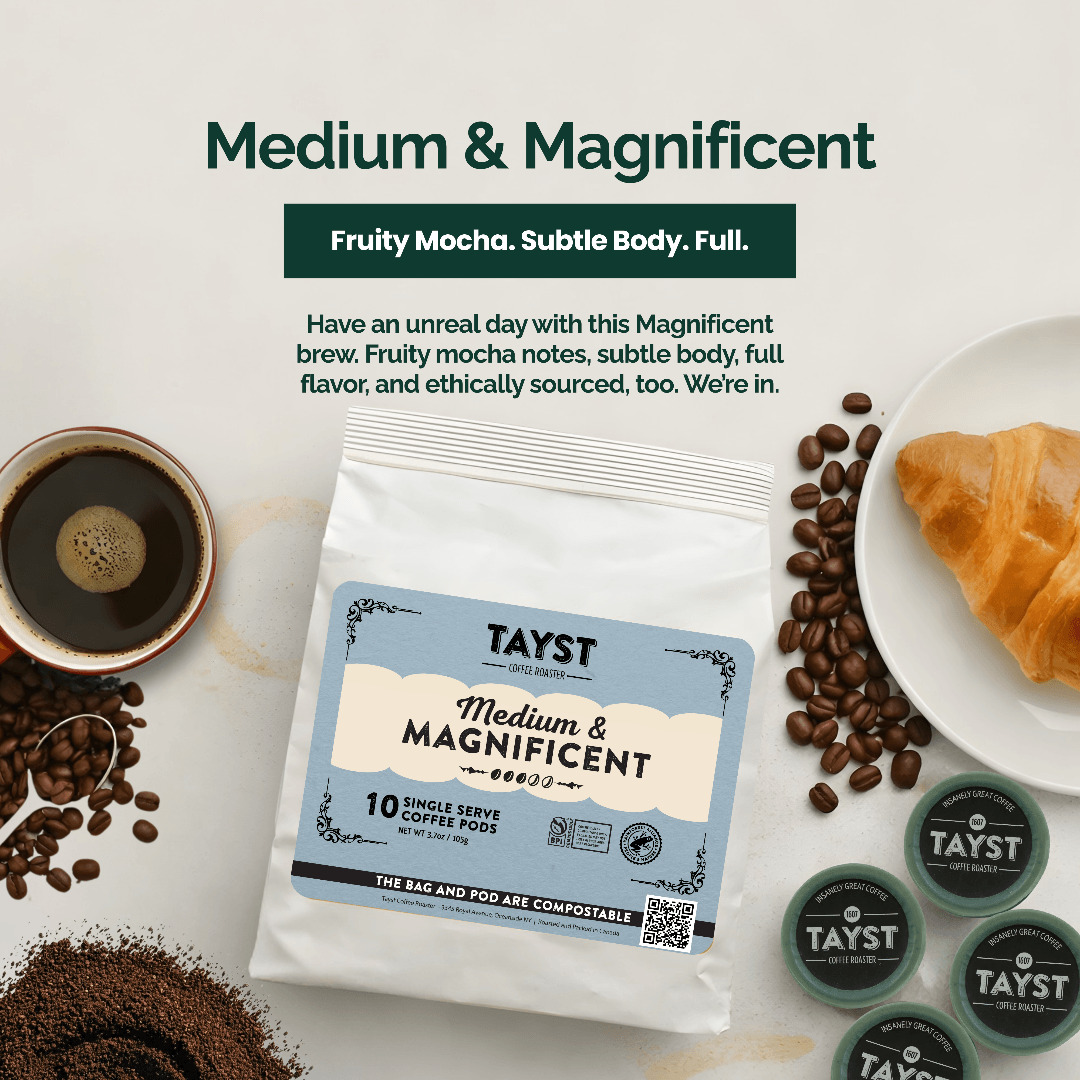 Tayst coffee pod package with coffee beans, a cup of coffee, and a croissant on a white background.