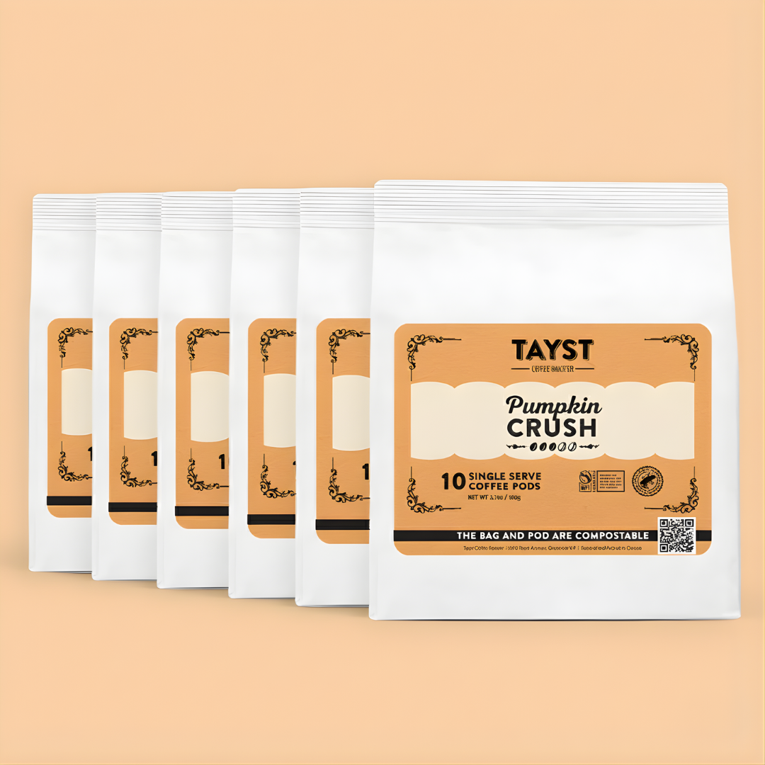 Tayst Pumpkin Crush coffee packages on a beige background