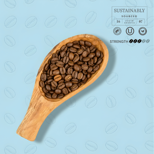 Wooden scoop filled with coffee beans on a light blue background with coffee bean patterns.
