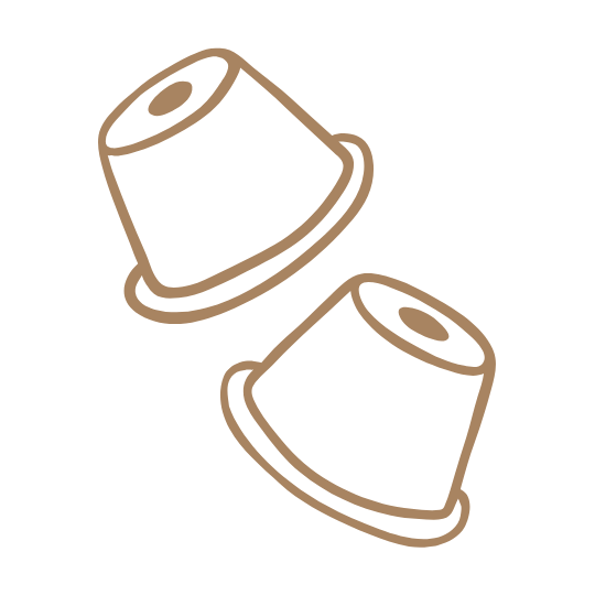 Two brown coffee pods on a green background