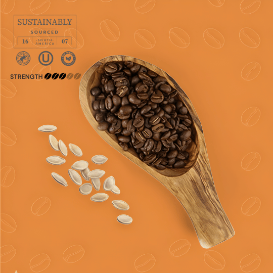 Wooden scoop filled with pumpkin flavored coffee beans on an orange background with coffee bean patterns.