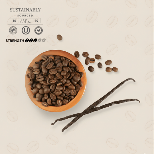 Vanilla flavored coffee beans in a bowl with vanilla beans on a textured beige background