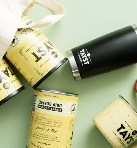 Tayst coffee ground coffee with a bag, tins, and mugs