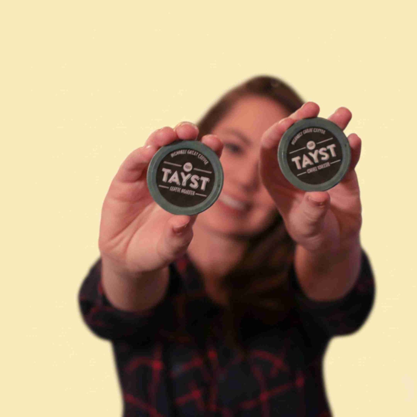 Person holding two keurig compostable pods
